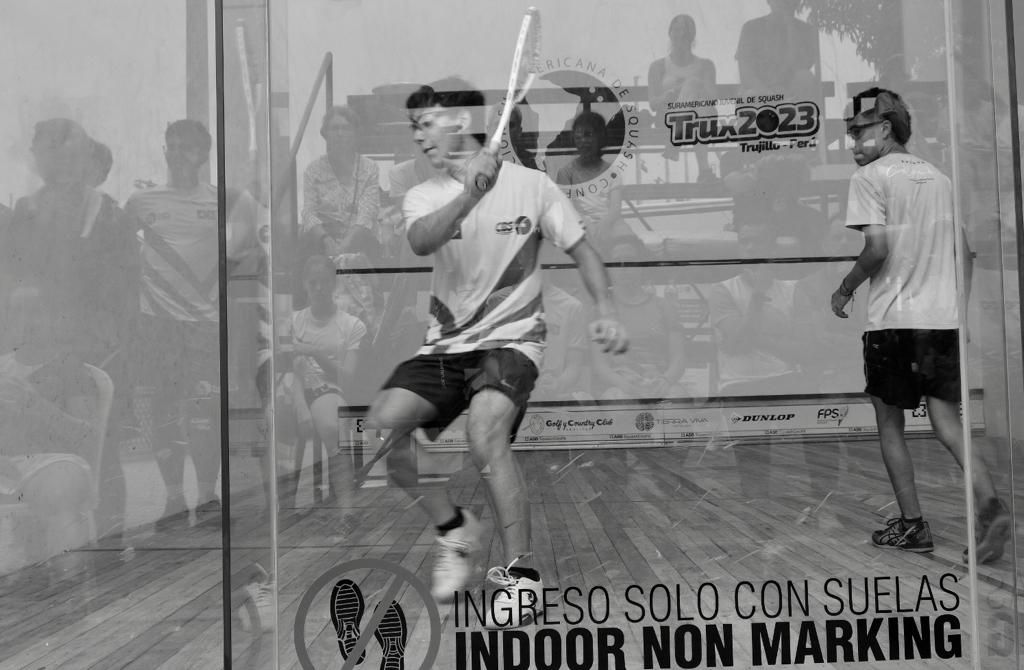 Uma foto em preto e branco de dois homens jogando squash