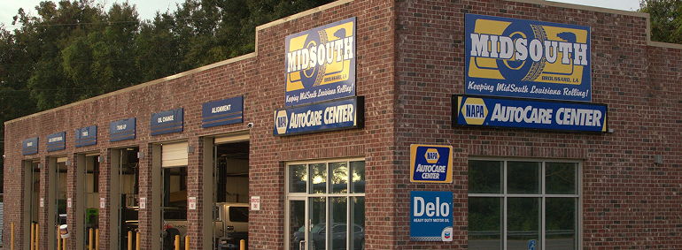 Brick building: Midsouth AutoCare Center, with bays and logos for Napa and Delo.