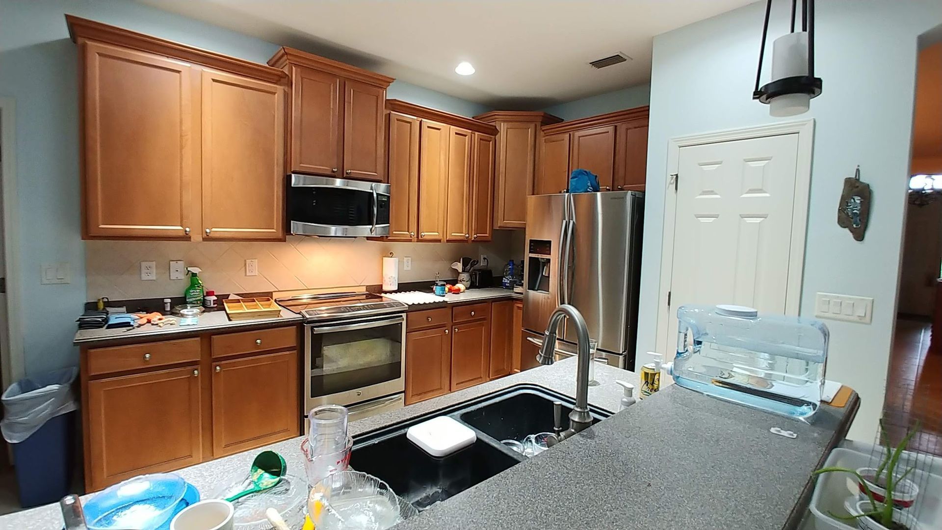 A kitchen with stainless steel appliances and wooden cabinets