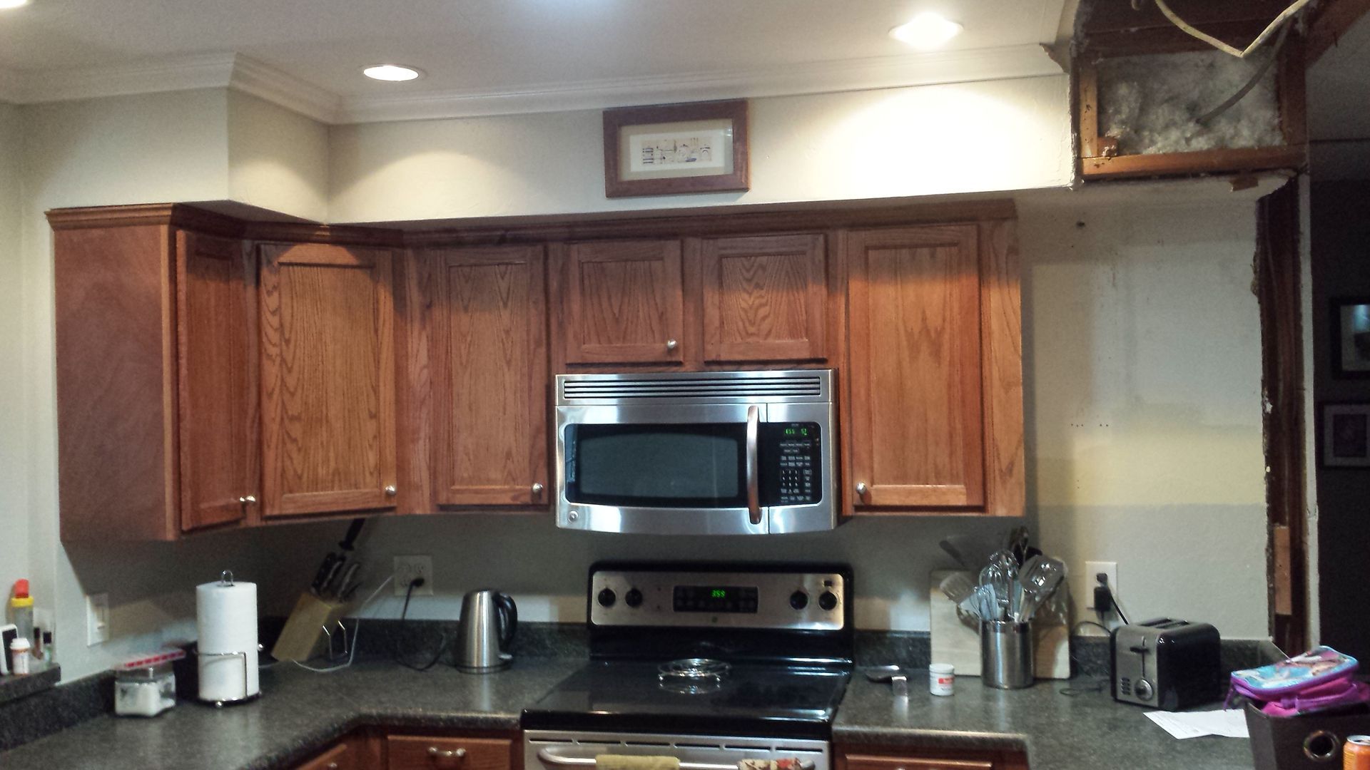 A kitchen with stainless steel appliances and wooden cabinets