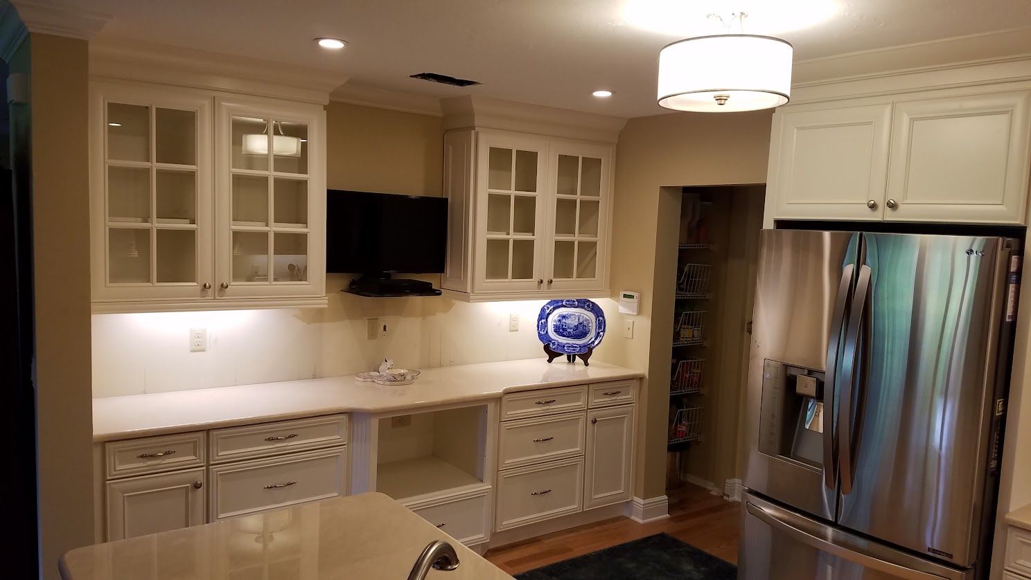 A kitchen with white cabinets and stainless steel appliances.