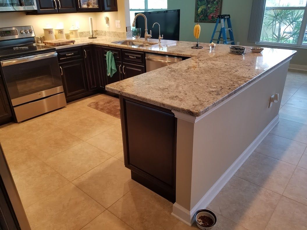 A kitchen with stainless steel appliances and granite counter tops.