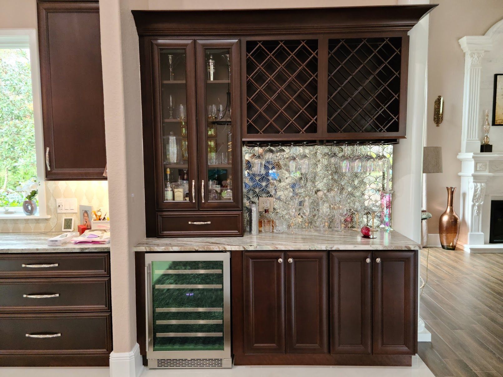 A kitchen with a wine cooler and a wine rack.