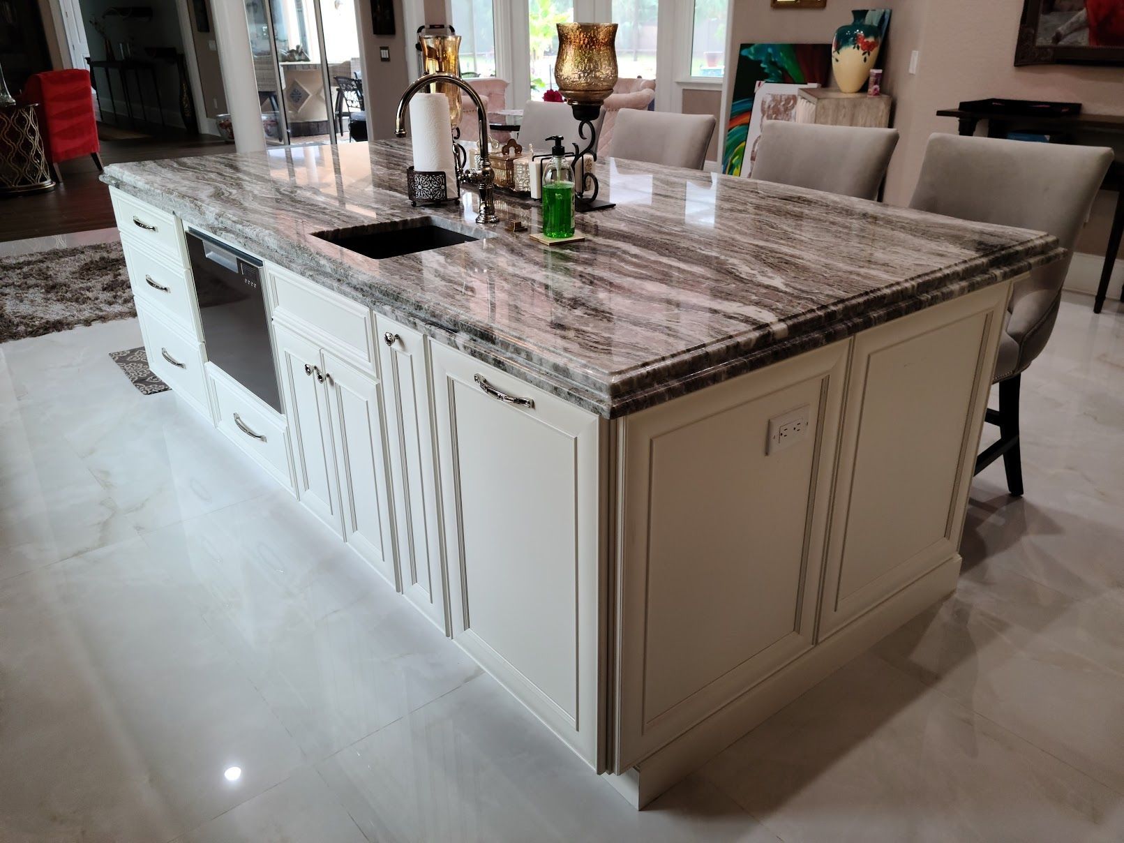 A kitchen with a large island and a sink