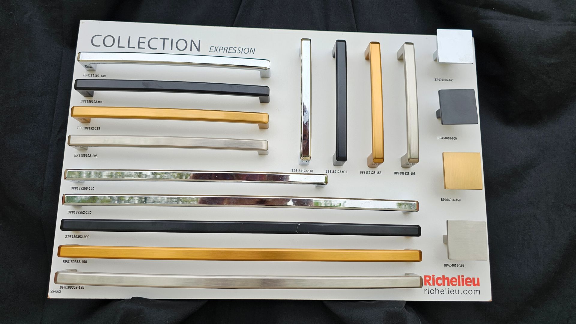 A collection of different colored handles on a white board