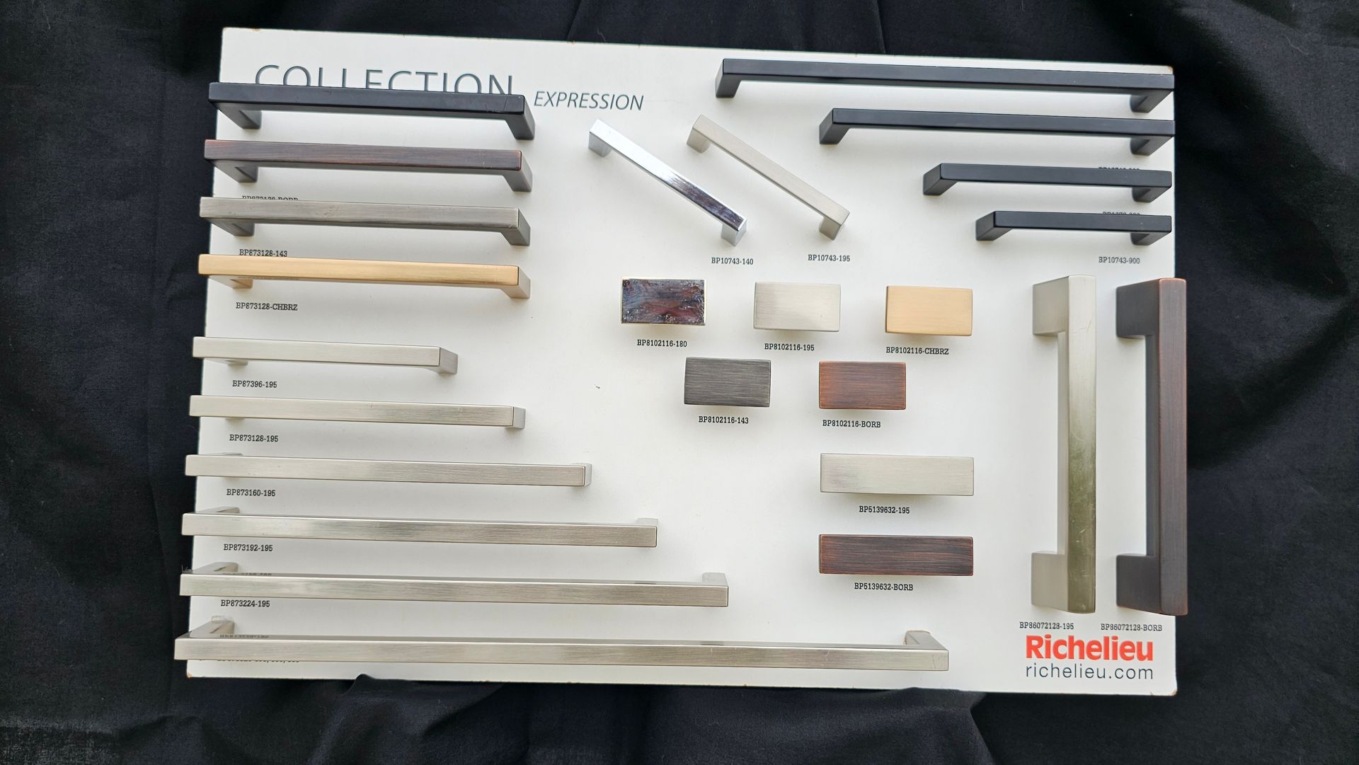 A collection of handles is displayed on a white board