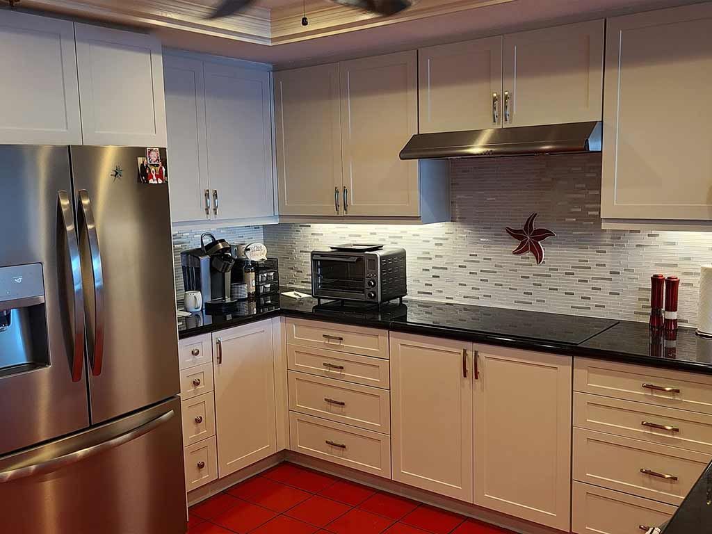 A kitchen with stainless steel appliances and white cabinets