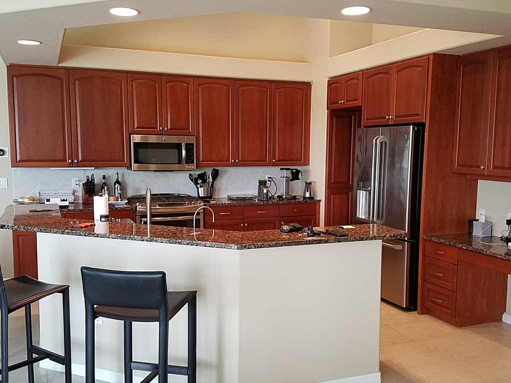 A kitchen with stainless steel appliances and wooden cabinets