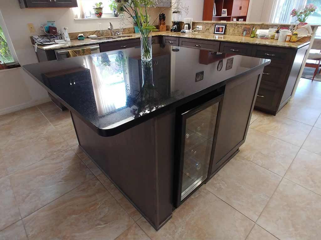 A kitchen with a large island and a refrigerator