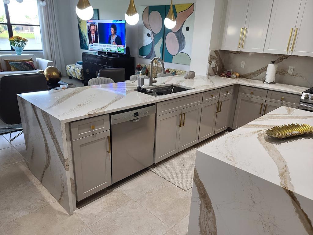 A kitchen with a large island and stainless steel appliances.