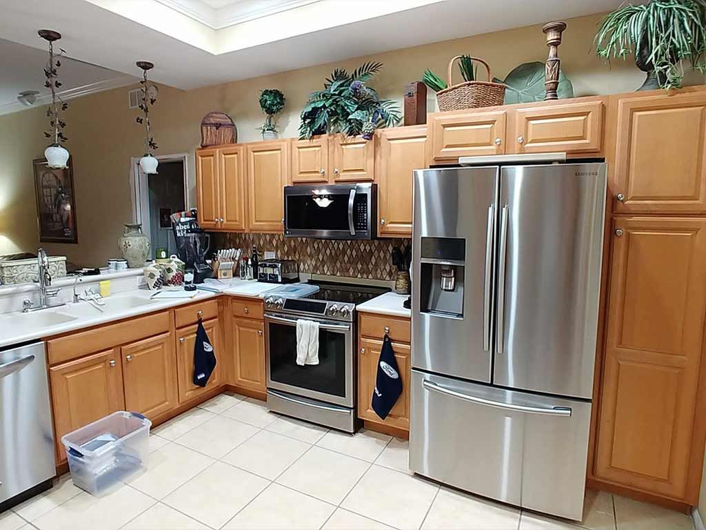 A kitchen with stainless steel appliances and wooden cabinets