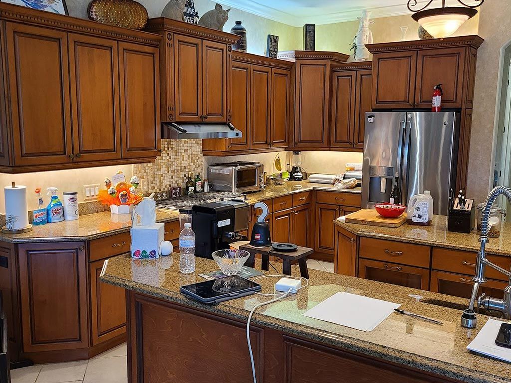 A kitchen with wooden cabinets and granite counter tops.