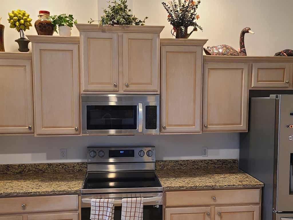 A kitchen with stainless steel appliances and wooden cabinets