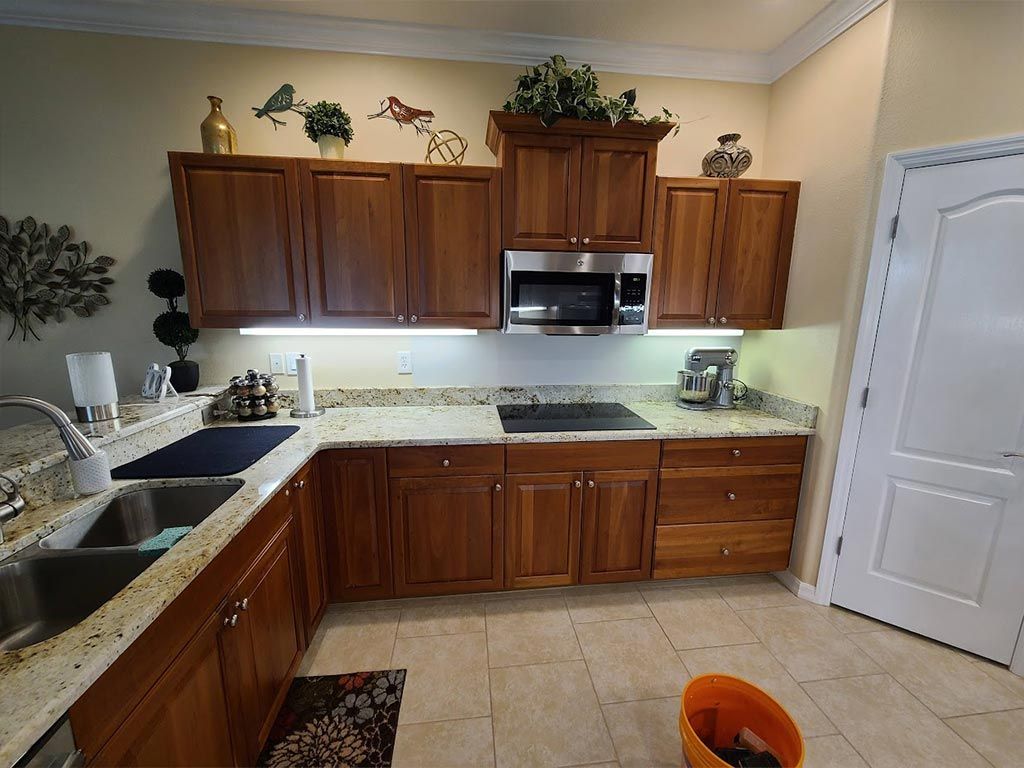 A kitchen with wooden cabinets and granite counter tops