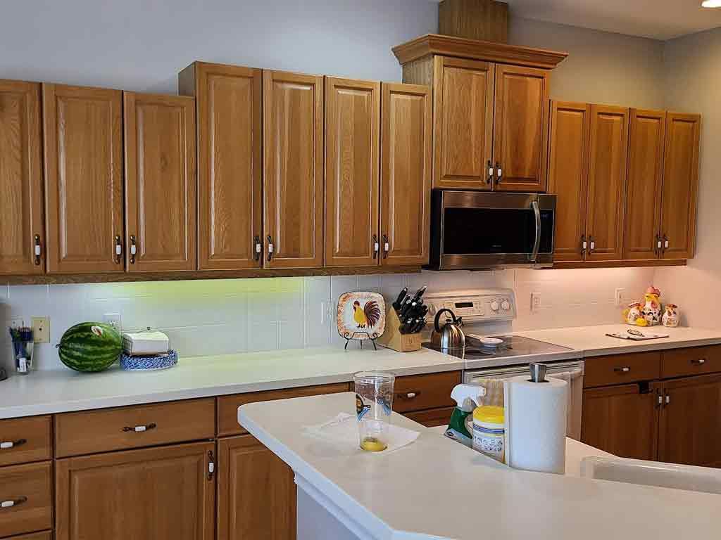 A kitchen with wooden cabinets and stainless steel appliances