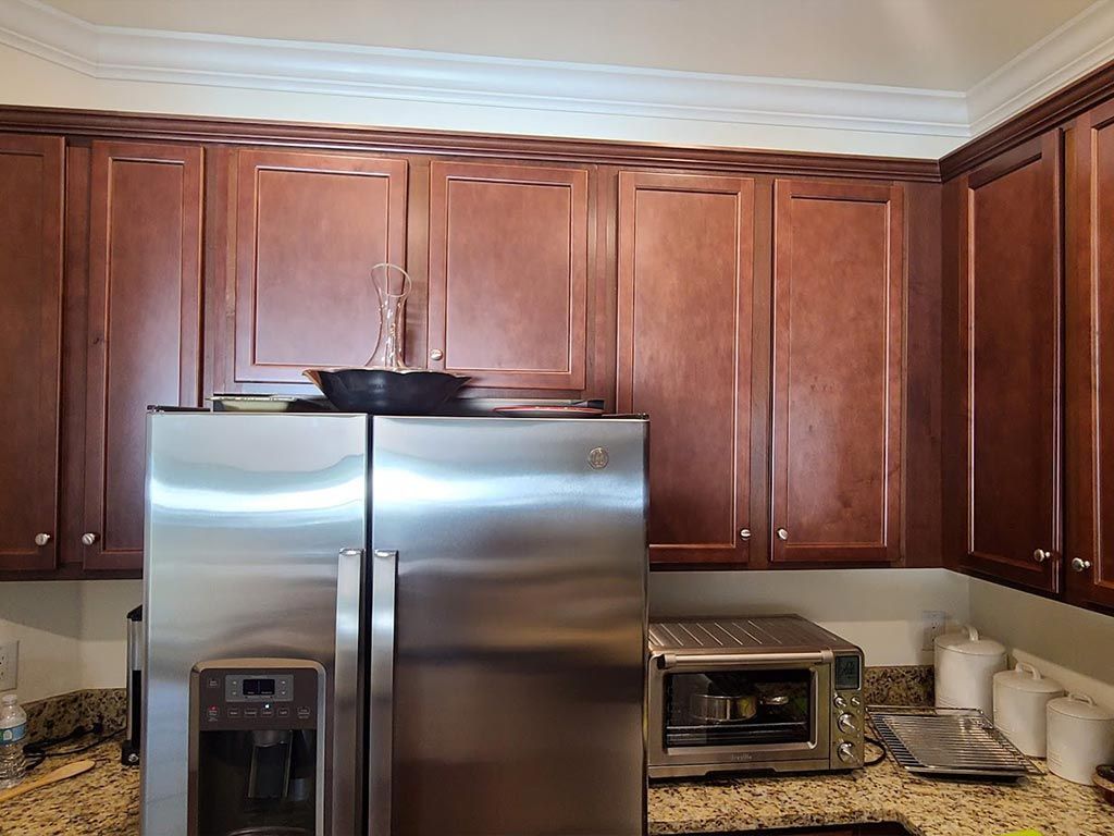 A kitchen with stainless steel appliances and wooden cabinets