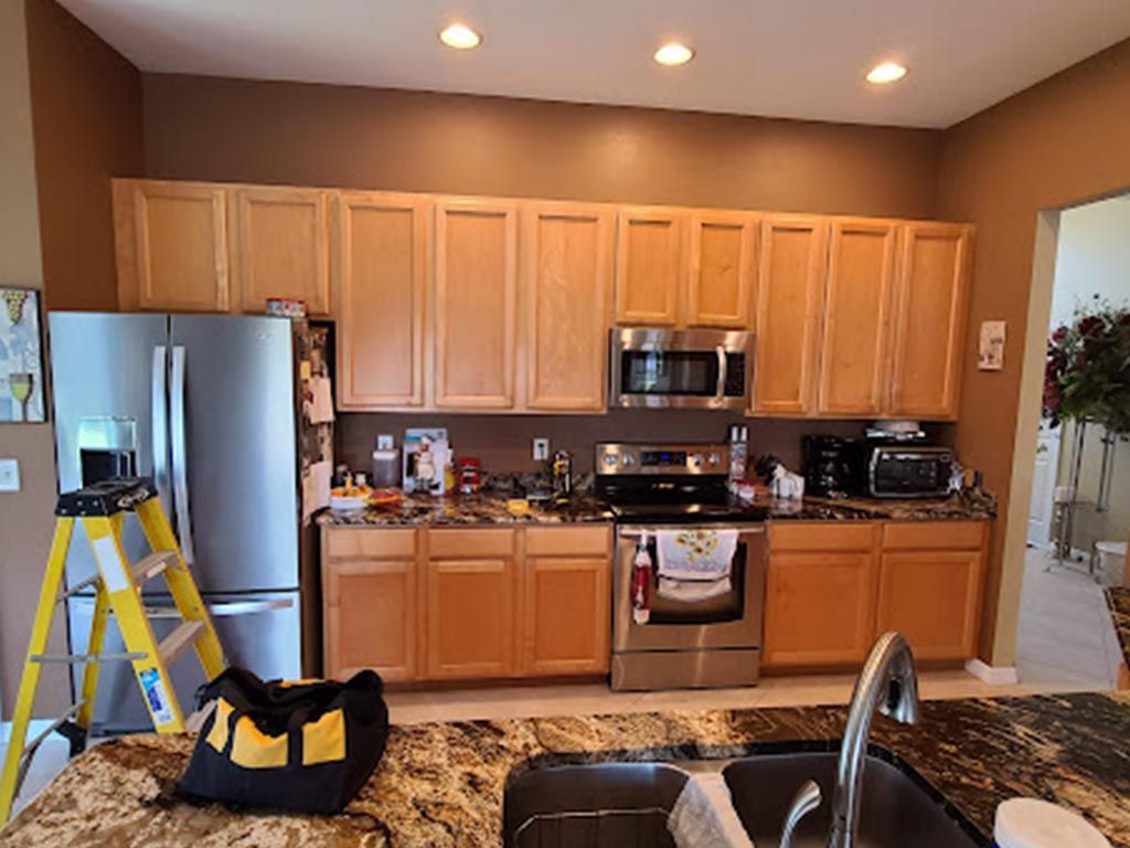 A kitchen with wooden cabinets and stainless steel appliances.