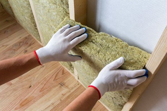Insulation Expert — Putting In Insulation Batt Into Wall in Oak View, CA