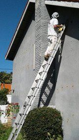 Insulation — Man In Ladder Fitting Insulation Board in Oak View, CA