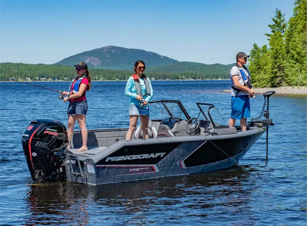 A group of people are fishing in a boat on a lake.