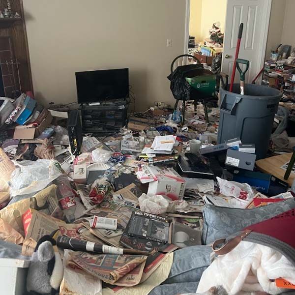 a living room filled with lots of junk and a television