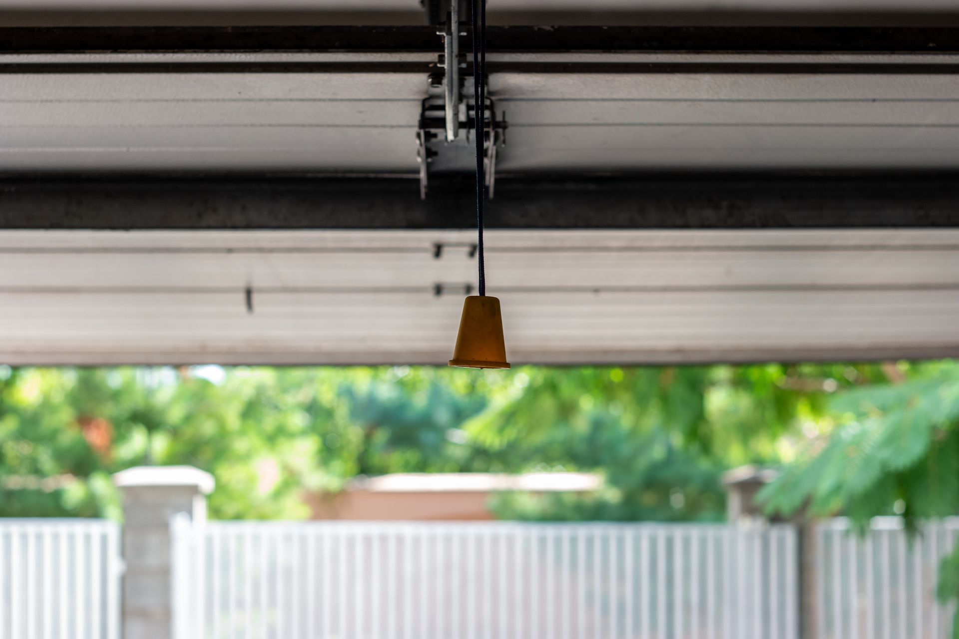 A close up of a garage door with a light hanging from it.