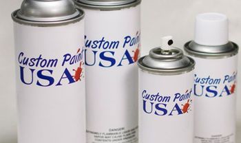 Three cans of custom paint usa are sitting on a table