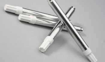 Three stainless steel pens with white caps are crossed over each other on a table.