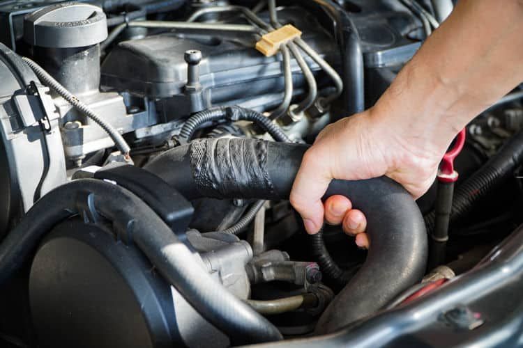 A person is working on the engine of a car. | Silvhorn Automotive