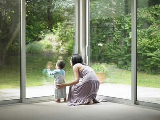 Mother and son looking out window — Abee Windows Screens Glass in Eugene, OR
