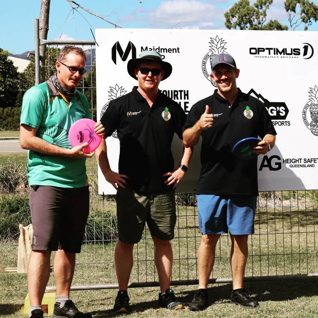 Three Men Standing in Front of a Sign That Says Optimus — Optimus 1 Insurance Brokers in Westcourt, QLD