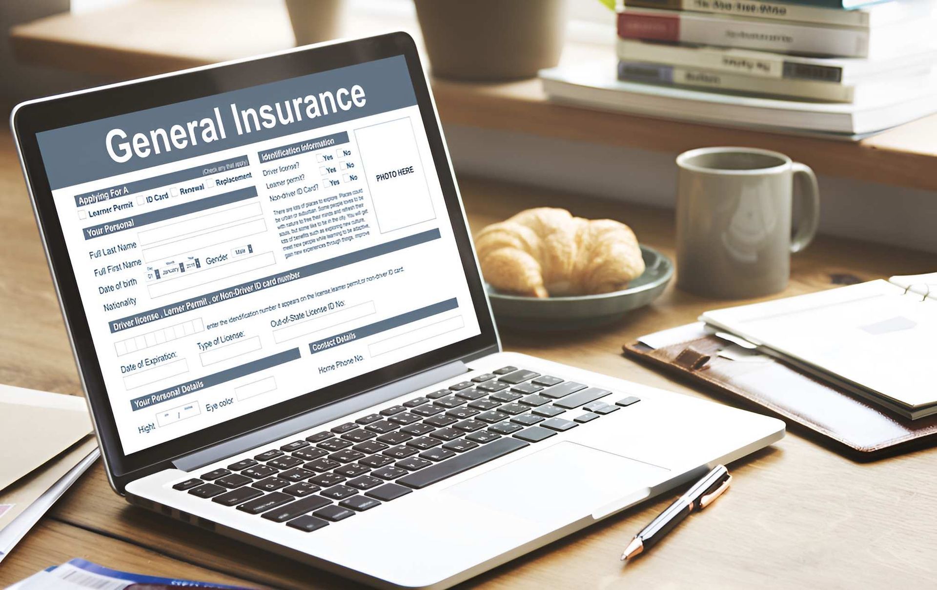 A Laptop Computer is Open to a Page About General Insurance — Optimus 1 Insurance Brokers in Westcourt, QLD