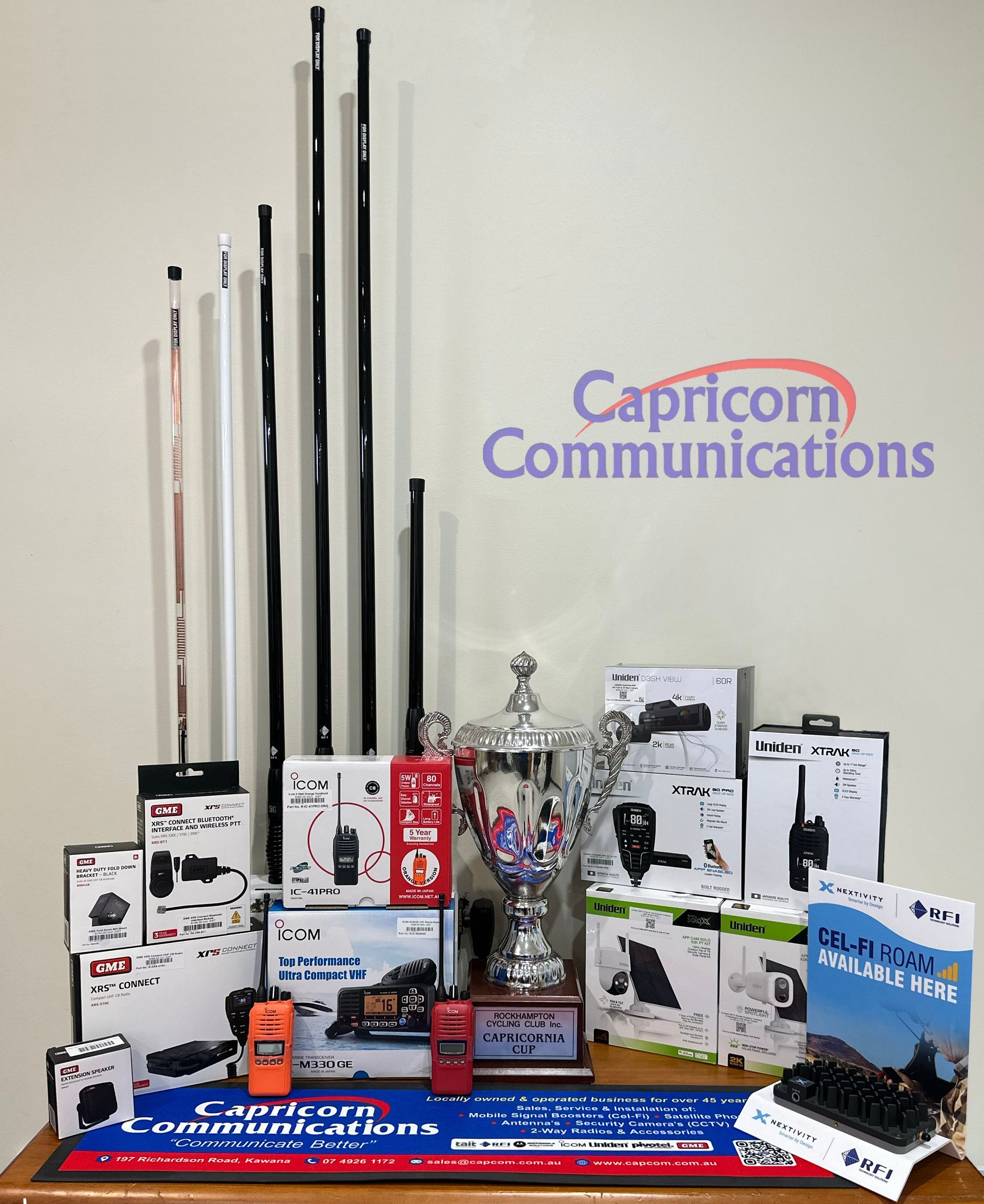 Display of radio communication equipment, antennas, and trophy, likely for a radio communications company, Capricorn Communications.