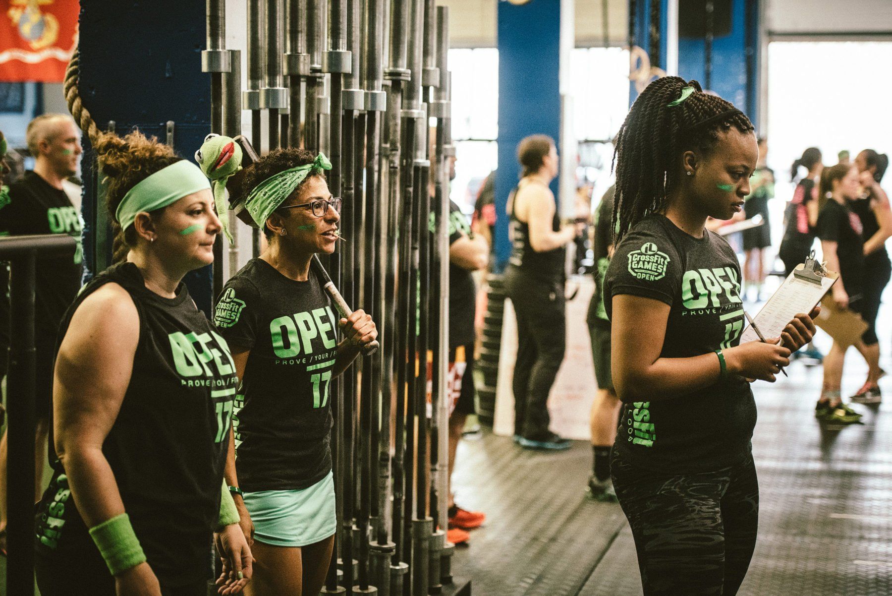 A group of women are standing next to each other in a gym.