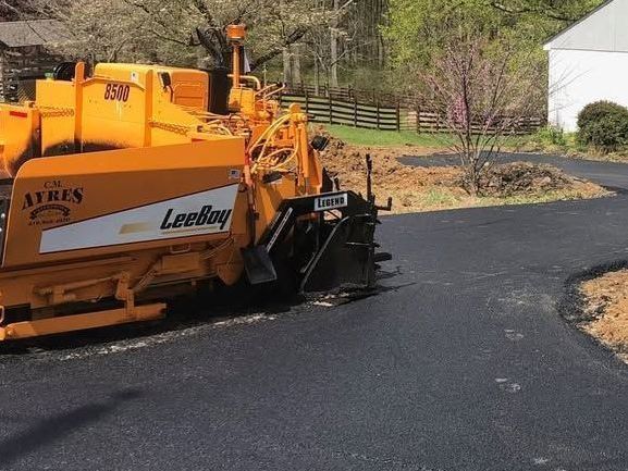 Driveway paving in progress by experienced Maryland asphalt contractor CM Ayres in Baltimore, MD