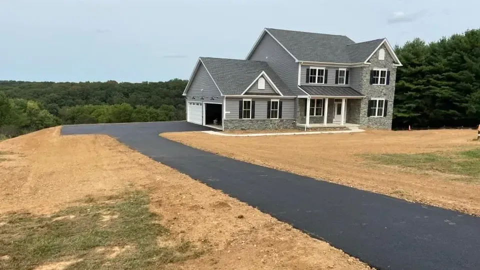 Smooth, finished asphalt driveway after installation by CM Ayres