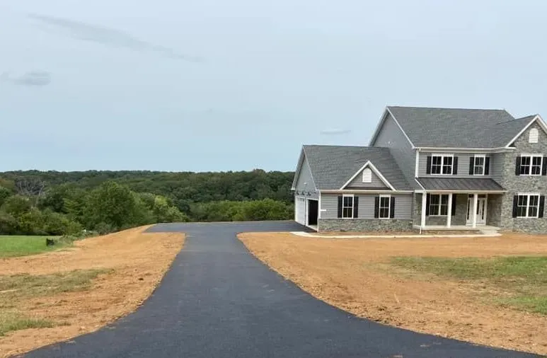 A large house with a driveway leading to it.