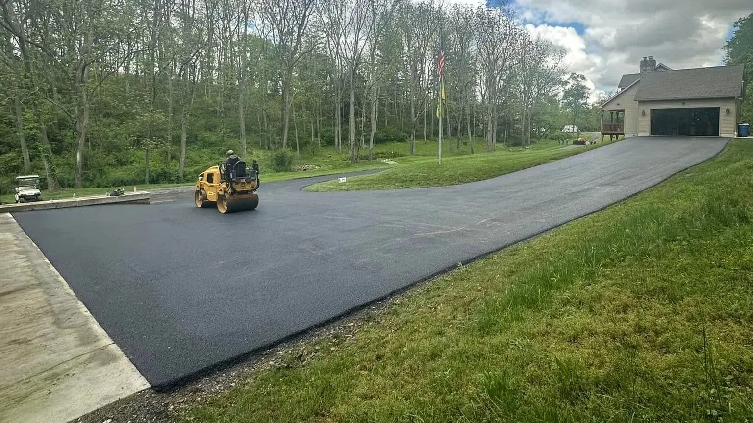 CM Ayres team member finishing a new asphalt driveway in Maryland.