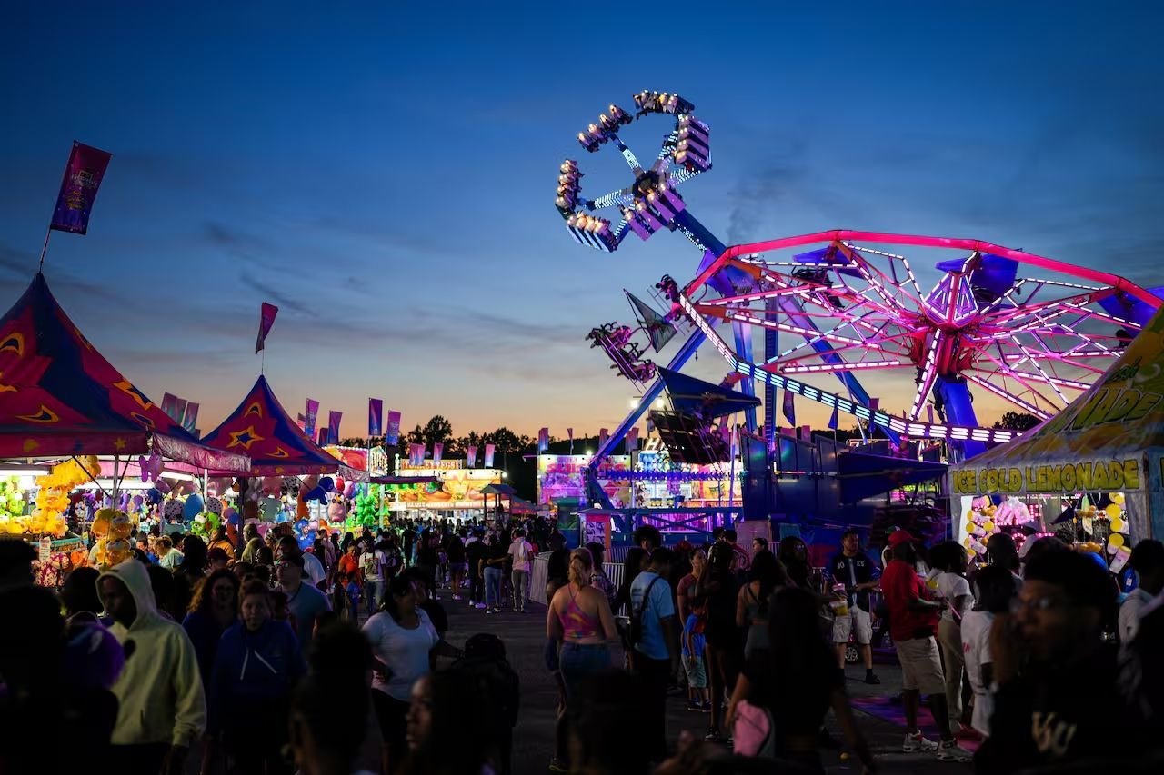 Various rides and booths illuminated at night at the Maryland State Fair in Timonium