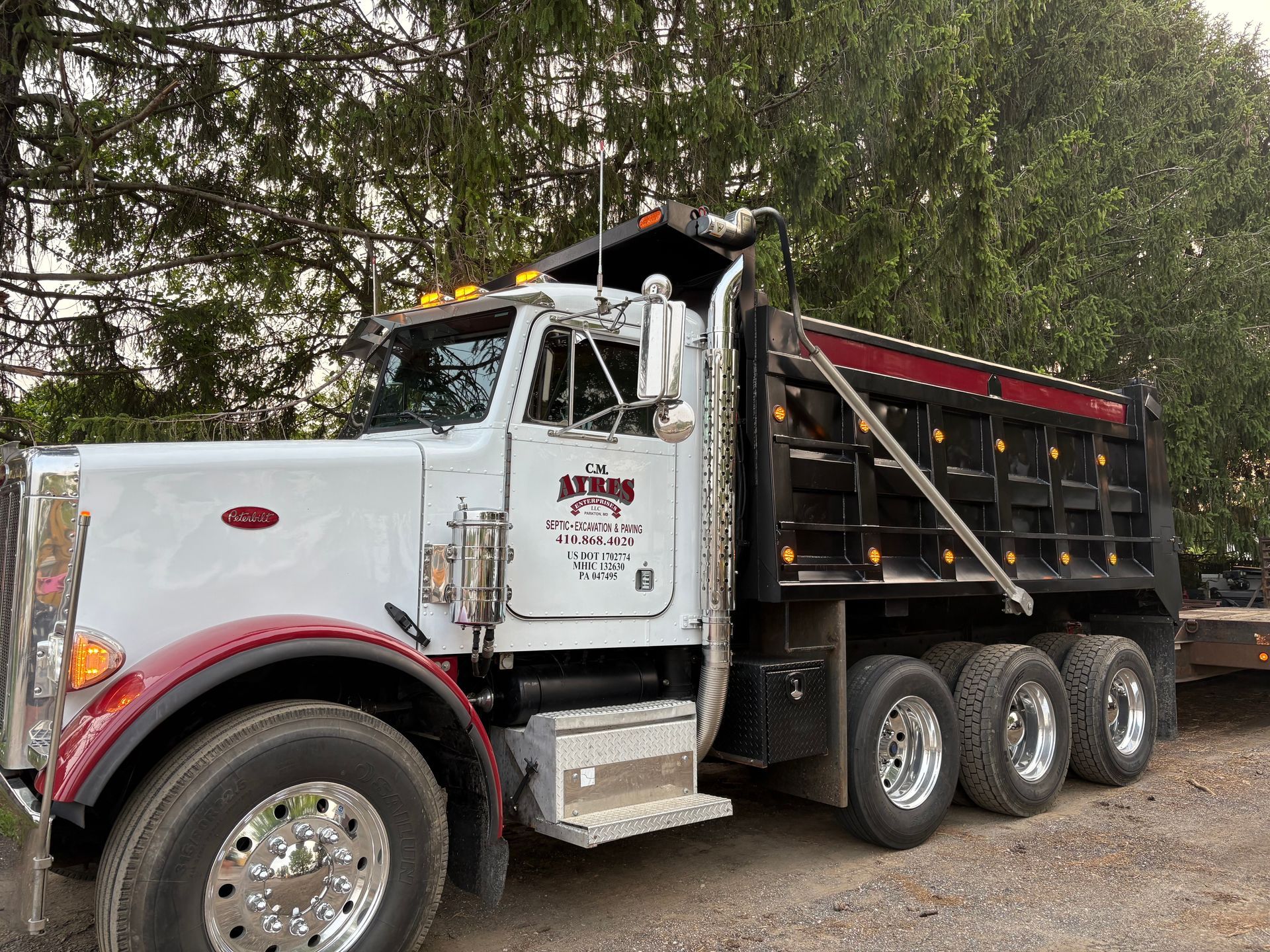 CM Ayres Enterprises truck with company logo at a driveway resurfacing project