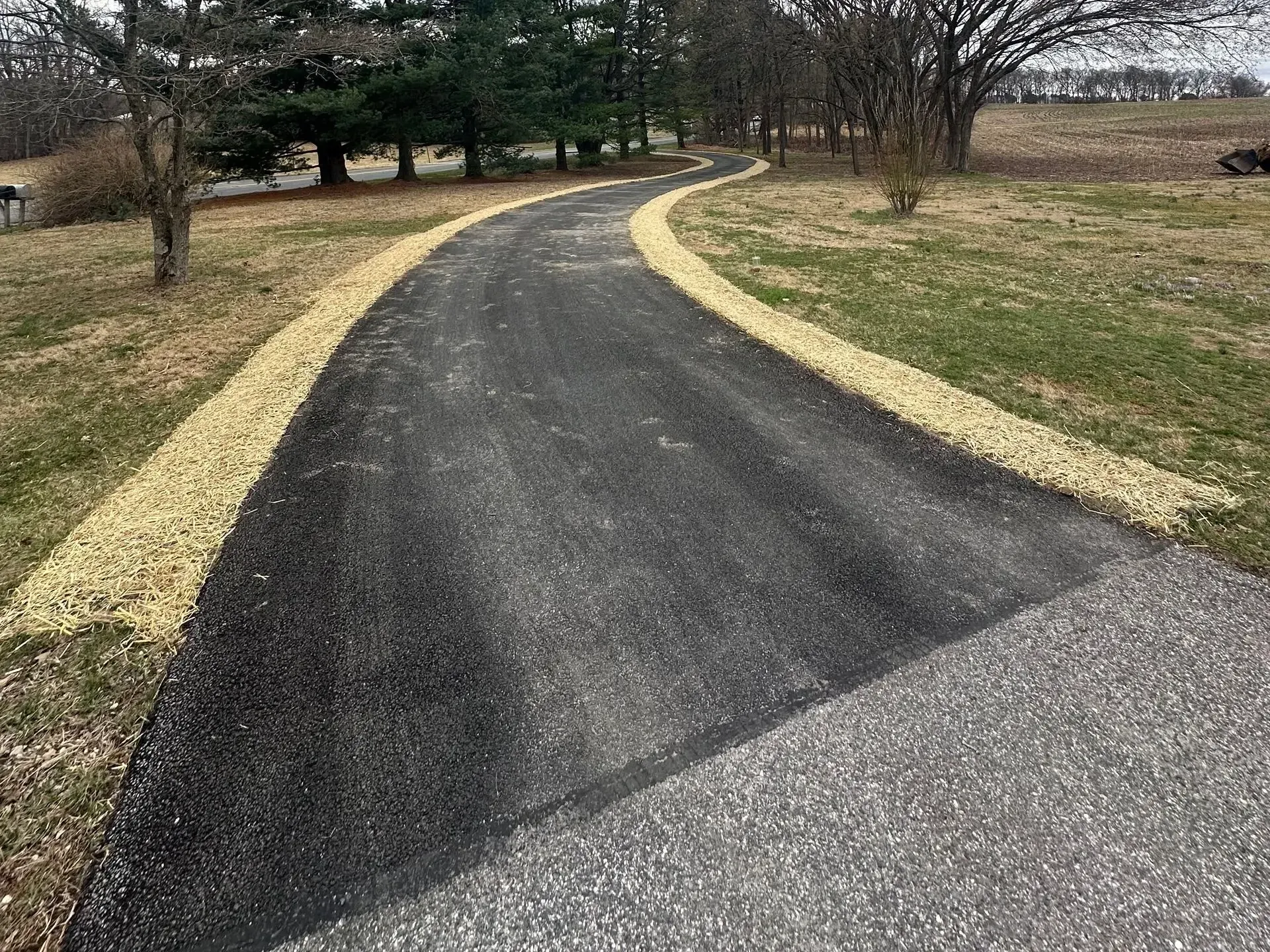 Freshly completed residential asphalt driveway by Maryland paving experts CM Ayres