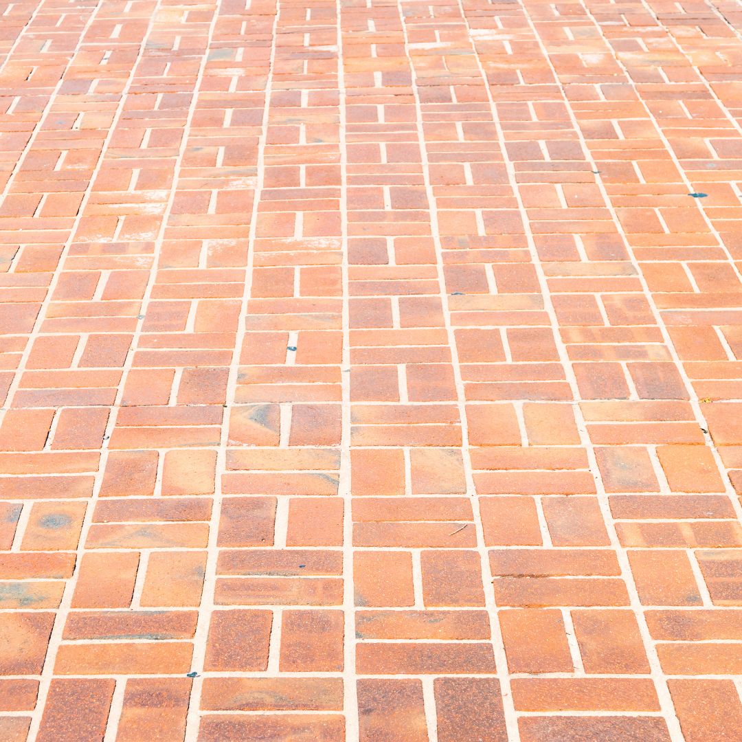 A close up of a brick floor with a geometric pattern.