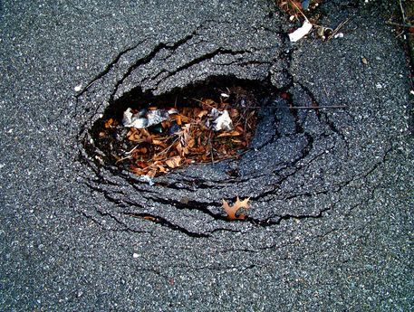 Pothole on Driveway Caused by Pooling Water - Repaired by CM Ayres Enterprises - Asphalt Paving Contractor in Baltimore, MD