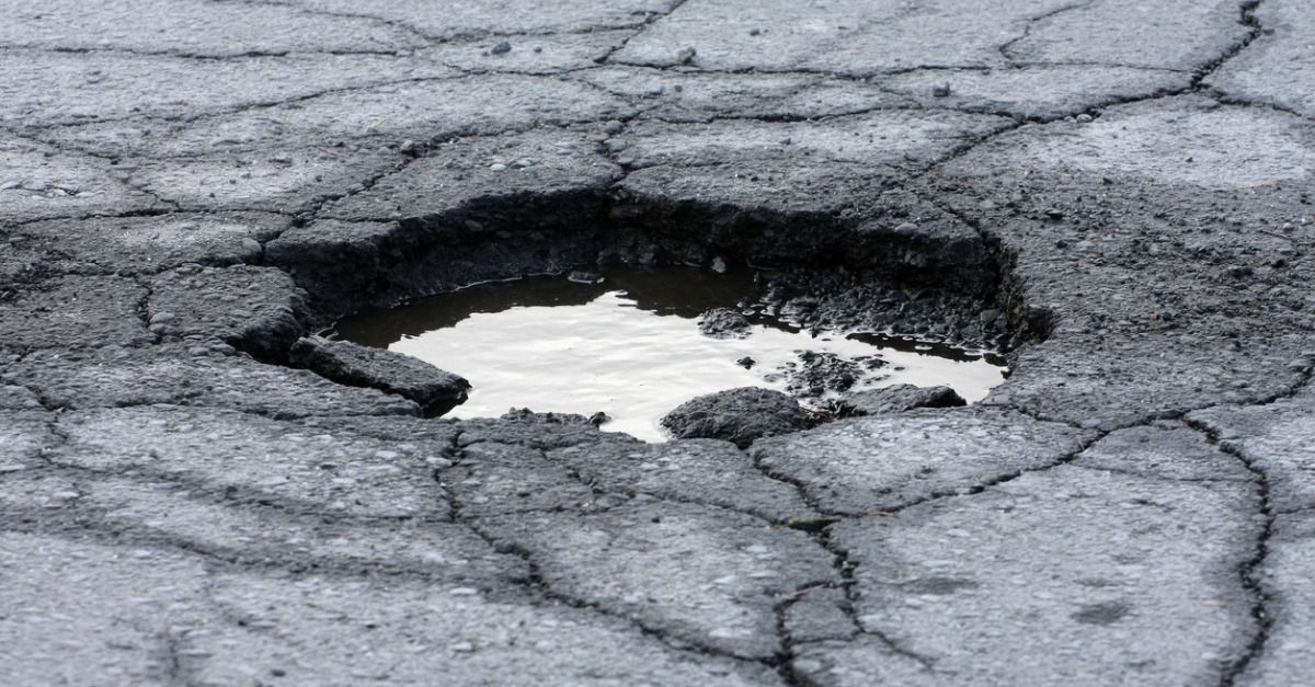 Pothole on Driveway Caused by Standing Water - Repaired by CM Ayres Enterprises - Asphalt Driveway Contractor in Baltimore, MD