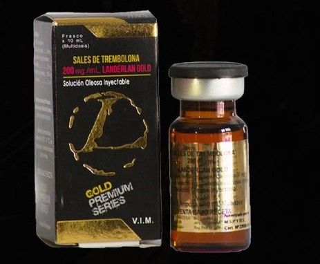 Una caja negra y dorada y un vial de vidrio ámbar de la solución inyectable de esteroides Landerlan Gold Trenbolone.