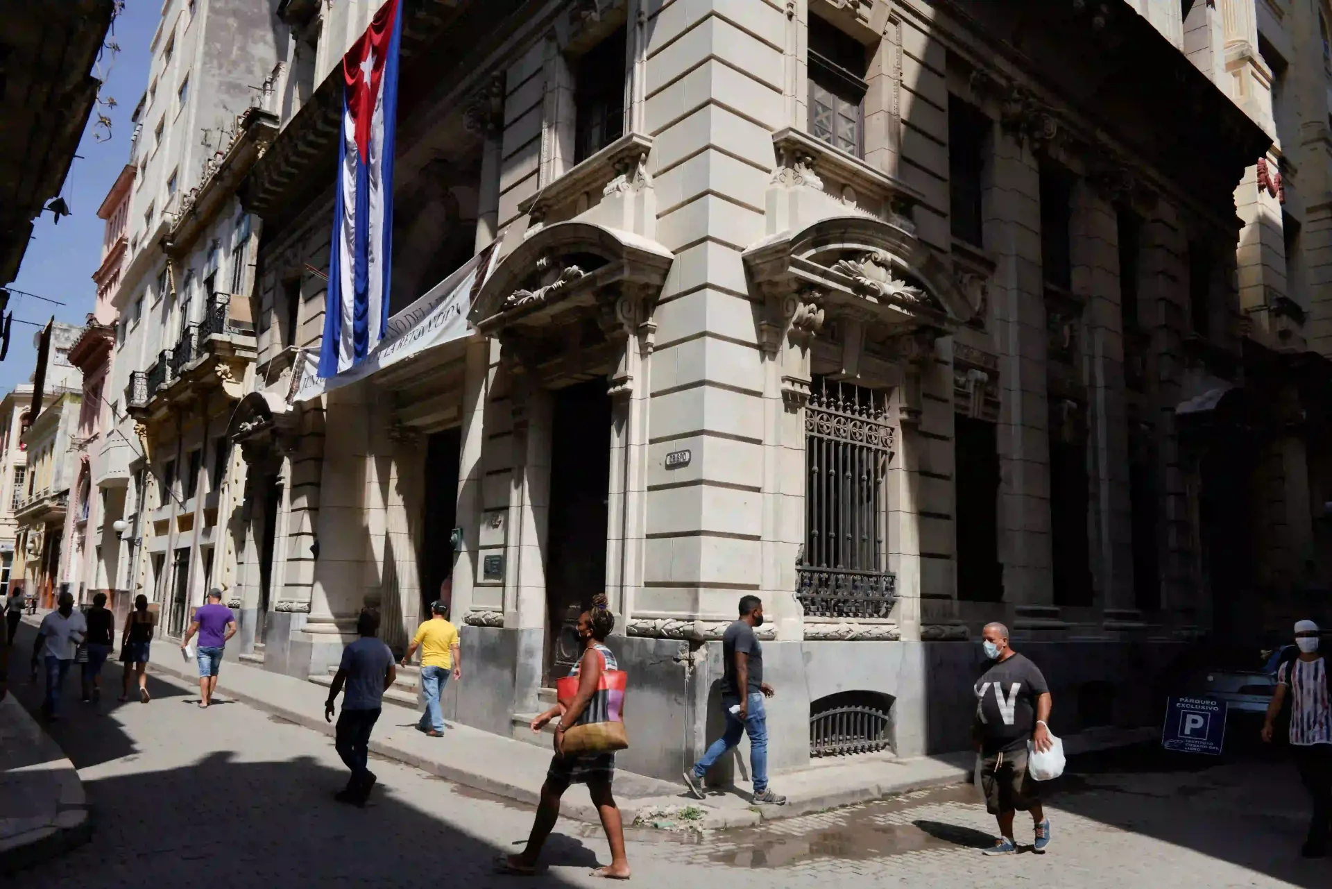 Street scene with people near historic building in Havana