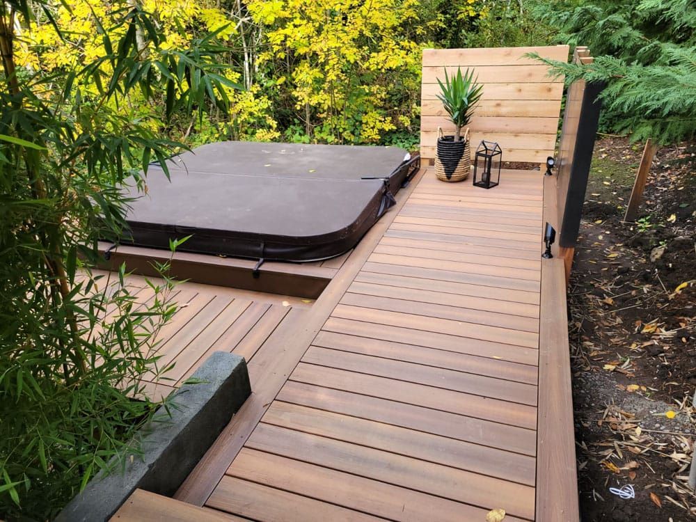 A deck in a backyard in Pasco, Washington, withb a hot tub built into it
