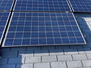 A group of solar panels are sitting on top of a roof.