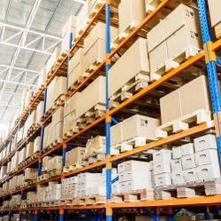 A large warehouse filled with lots of boxes and pallets.