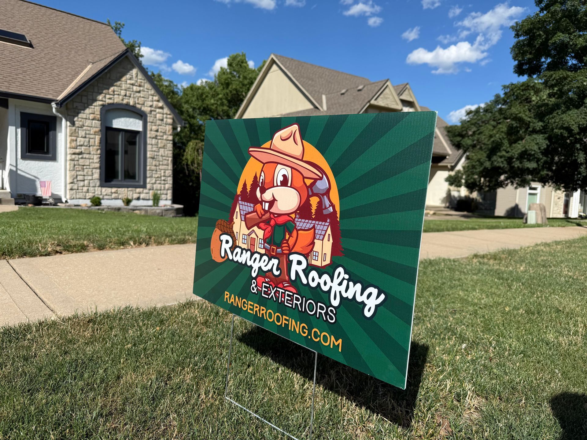 Ranger Roofing Yard sign in the front yard. A house with a new roof is shown behind it.